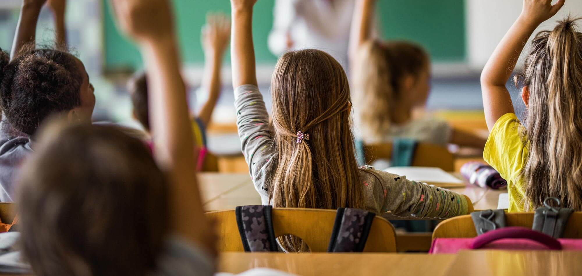 students raising hands